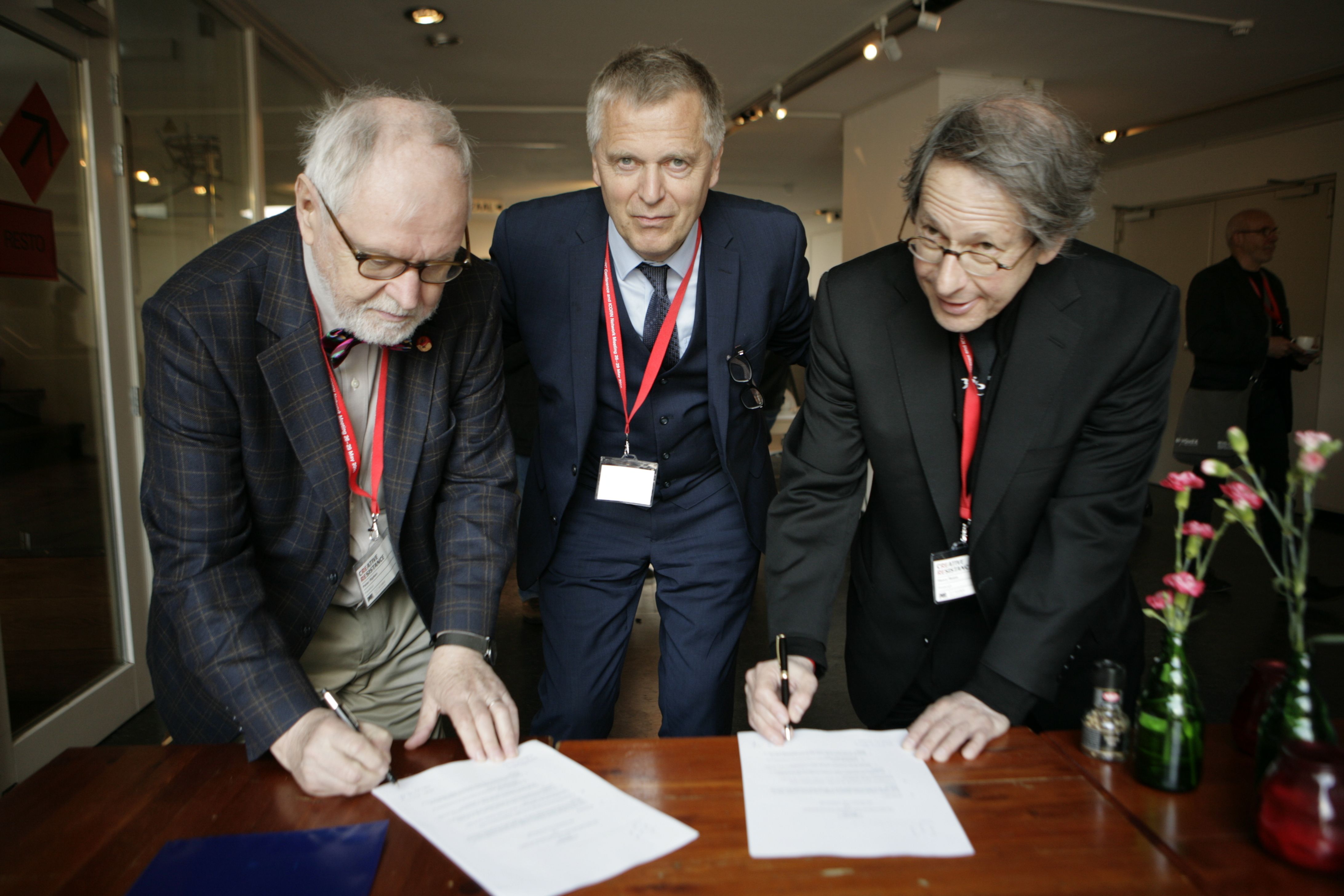 Left to right: Peter Ripken, Helge Lunde, and Henry Reese signing the ICORN Membership Agreement between City of Asylum Pittsburgh and ICORN in 2015. Photo: ICORN.