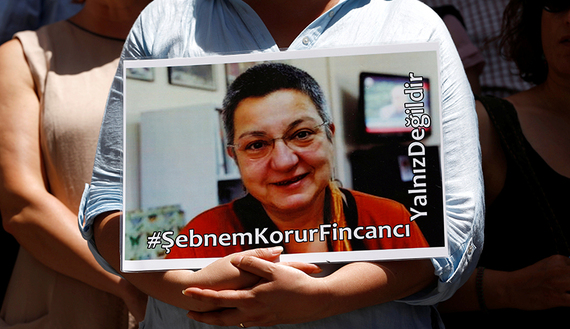 A demonstrator holds a picture of Sebnem Korur Fincanci, president of Turkey's Human Rights Foundation, during a protest against the arrest of three prominent campaigners for press freedom, in front of the pro-Kurdish Ozgur Gundem newspaper in central Istanbul, June 21, 2016.  (photo by REUTERS/Murad Sezer). Photo.